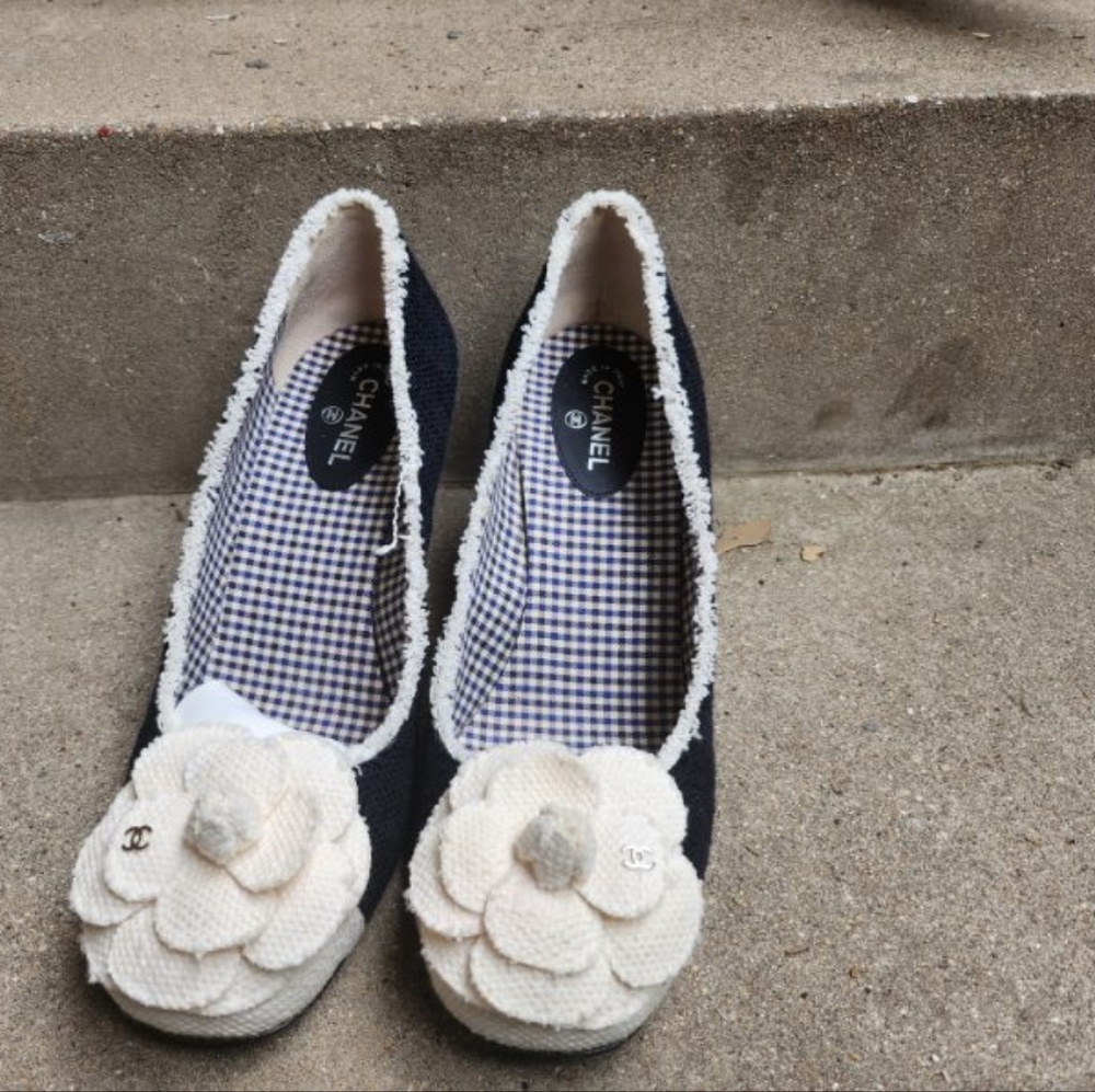 Channel Black canvas shoes trimmed with white canvas and a white canvas flower